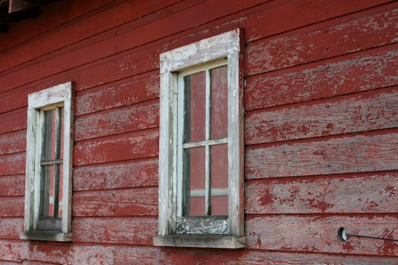 two windows on a building, with an odd design