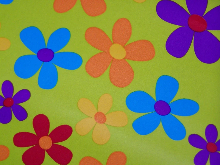 a green flower background with blue, red and orange flowers