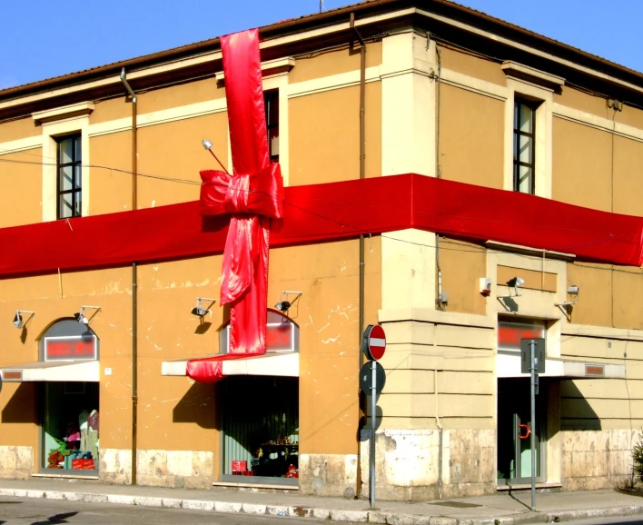 a storefront with an enormous red bow tied on top