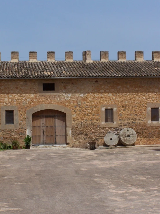 an old building with a lot of brick on the top and the front entrance