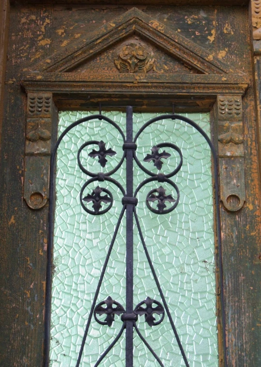 decorative iron work and glass on a door