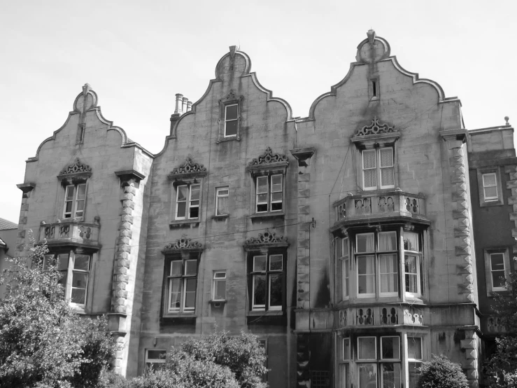 old building with unusual architecture and some landscaping