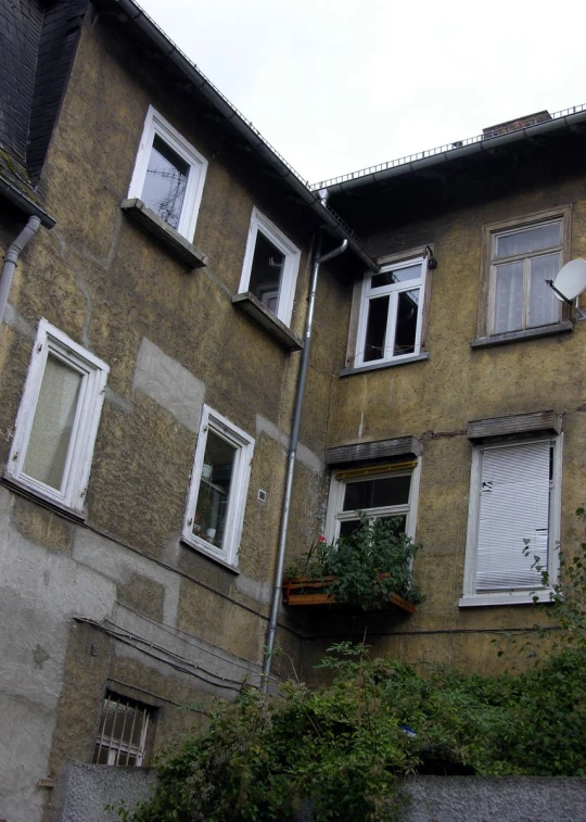 a building with many windows next to a street