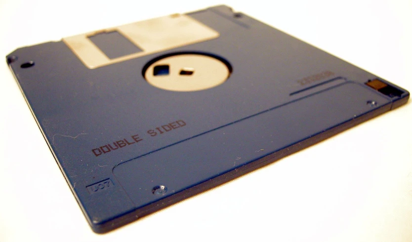 an old computer disk sitting on top of a table