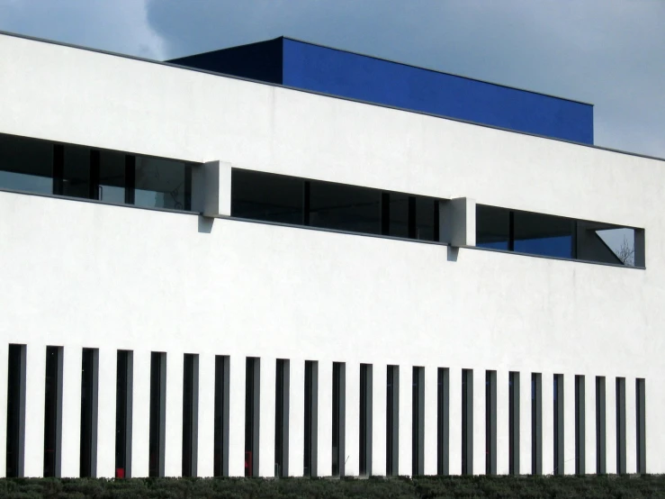 white building with large windows and black bars on front of it