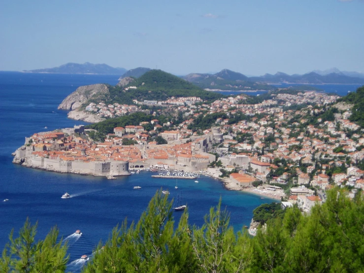 an aerial view of a town and some boats in the water