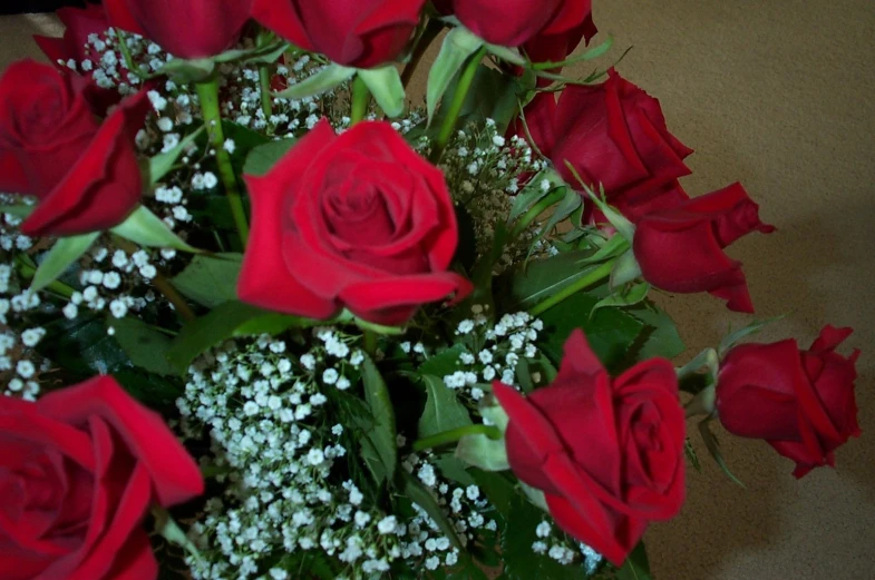 a bouquet of flowers with a few red roses