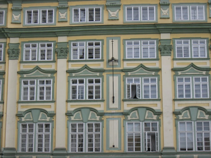 an apartment building with white and green trimming