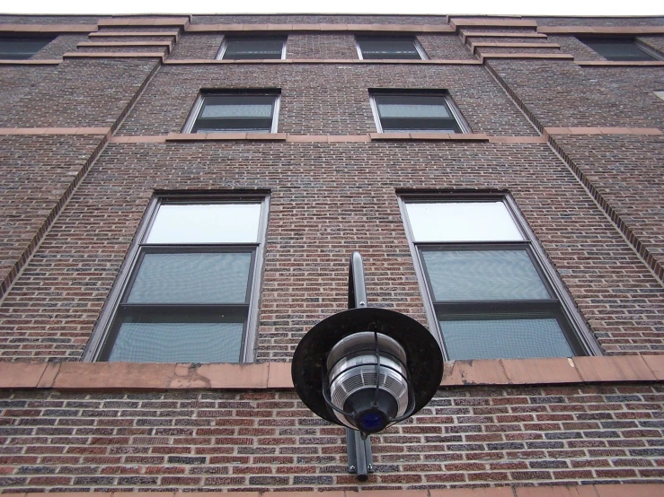 view from below of building window showing tv / dishwasher