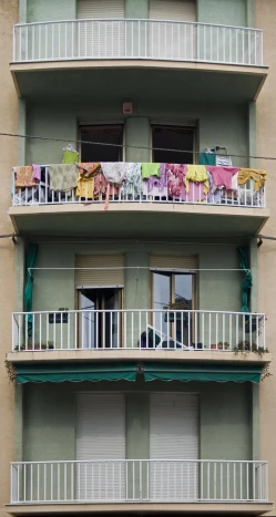 a balconied building with balconies and clothes on the balconies