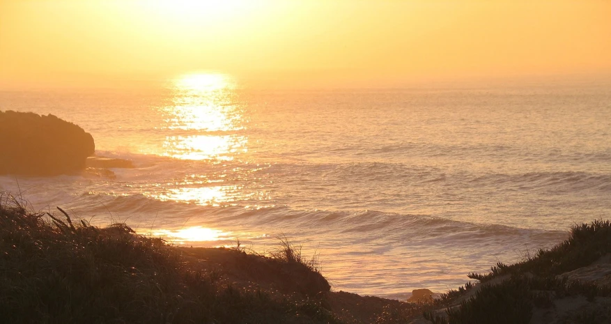 there is an image of a sunset on the ocean