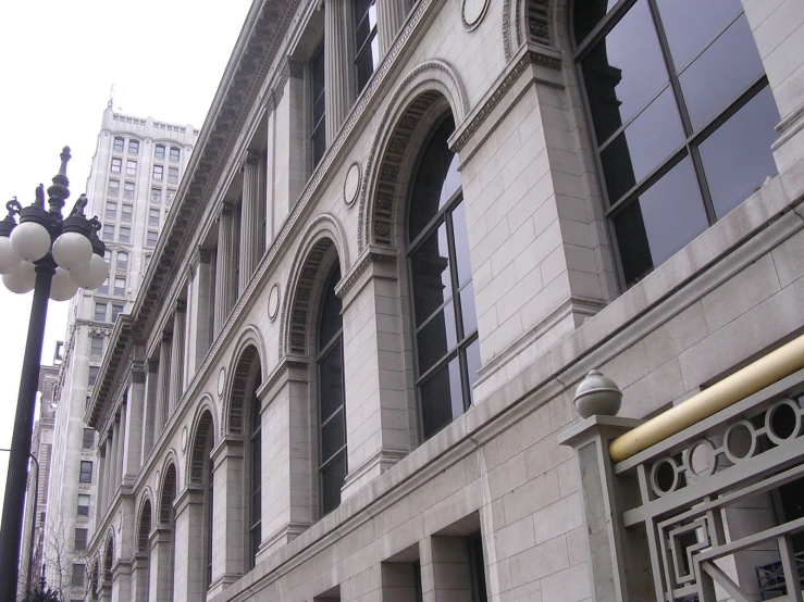 an old building on the corner of a street in front of tall buildings