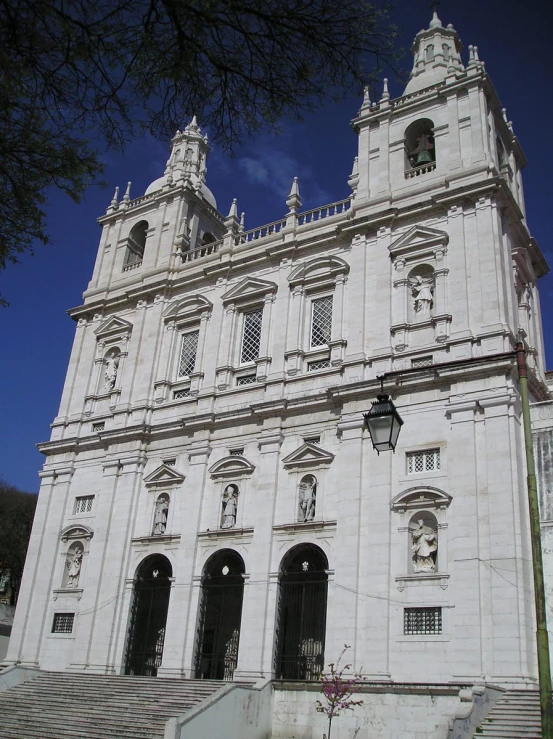 the large, ornate building is white with many windows