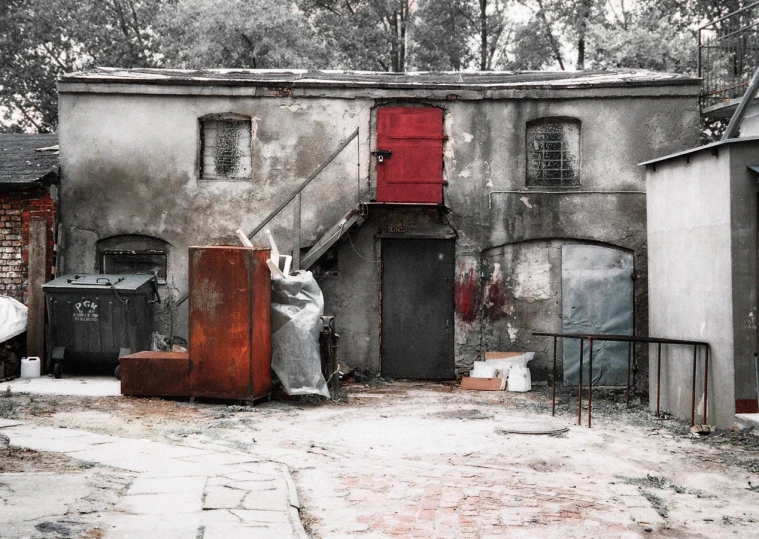 an old run down building with pieces of wood outside of it