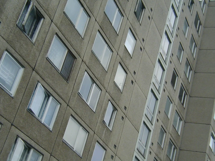 a clock is displayed next to a big building