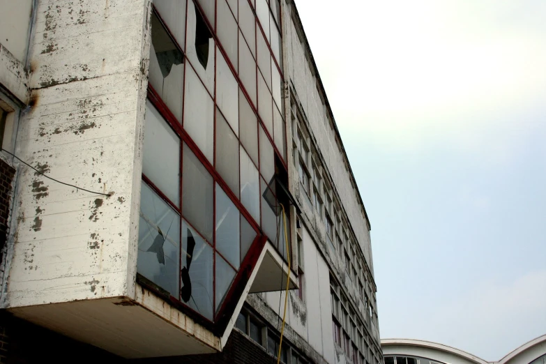 an image of a broken glass window on the side of a building