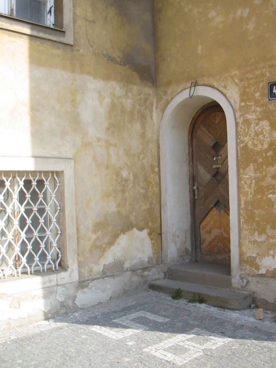 there is an arched doorway in a yellow wall