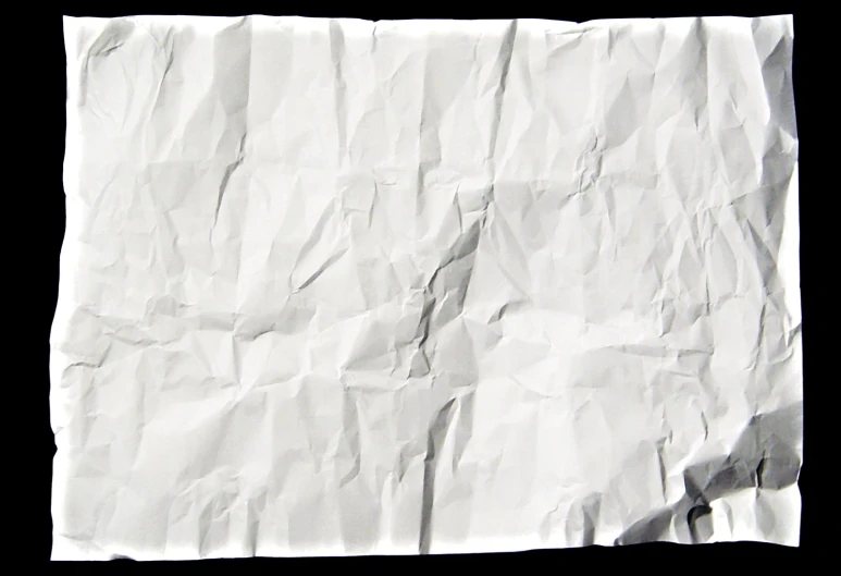 white crumpled paper is shown on a black background