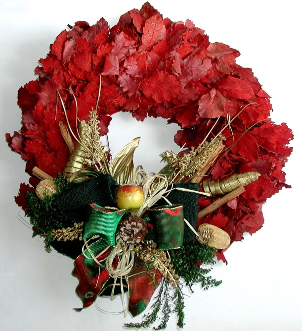 a wreath with an apple and leaves on it