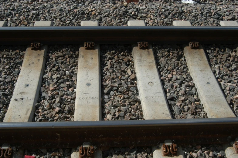 a train track with four wooden tracks running between it