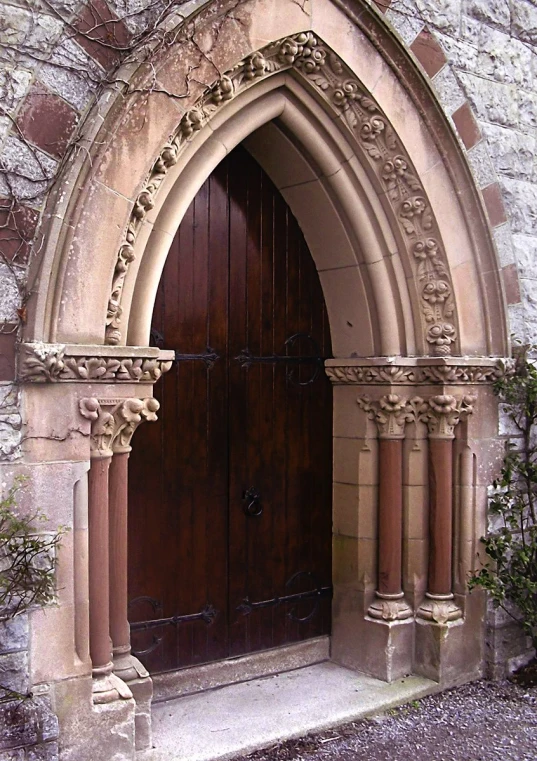 a brick building with a very large doorway that has columns in it