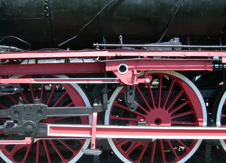 the wheels of an old fashioned locomotive on display