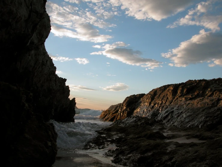 the view from a cliff, with water flowing in from it