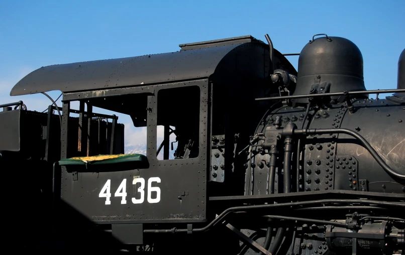 an old train sits on some tracks with a sky background