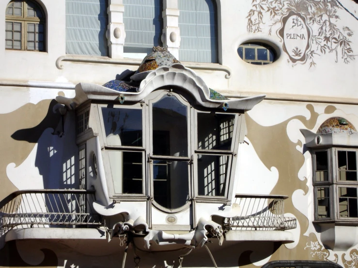 an ornate window and balconies with wrought iron