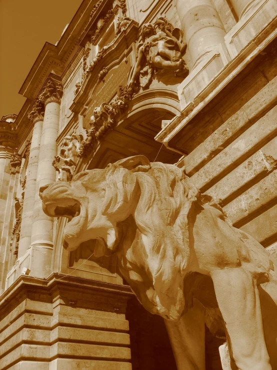 a stone lion standing outside of a building