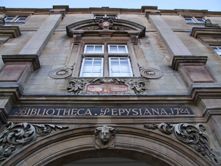 the entrance to the building has two signs above it