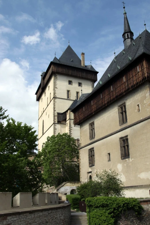 a large building with two towers surrounded by trees