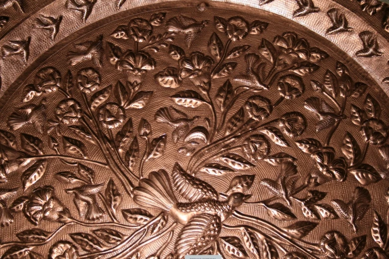 an image of a metal decoration with birds on it