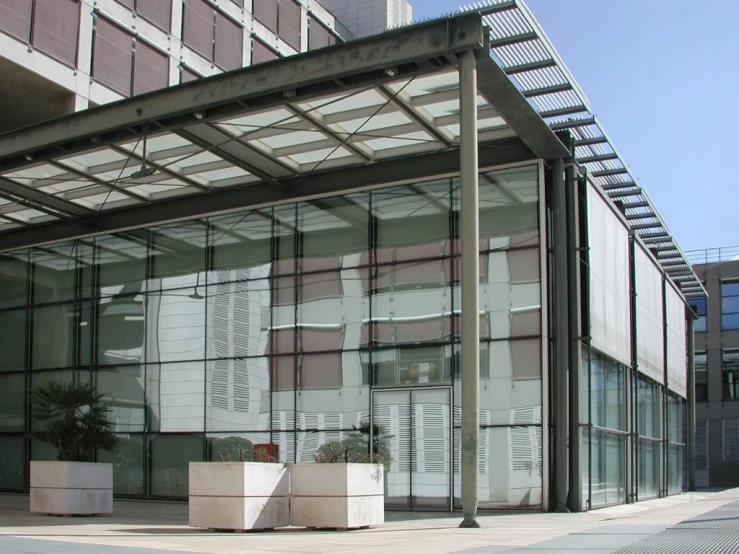 a tall building has a glass front and some windows