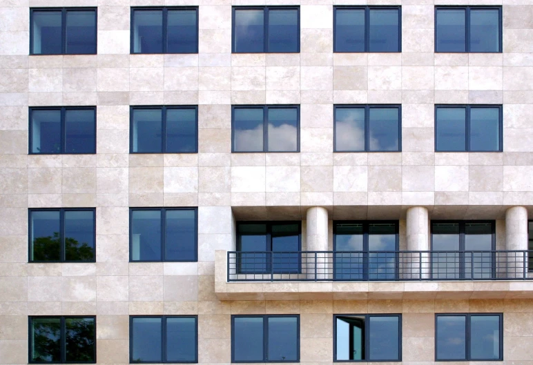 an older style building has balconies and concrete columns