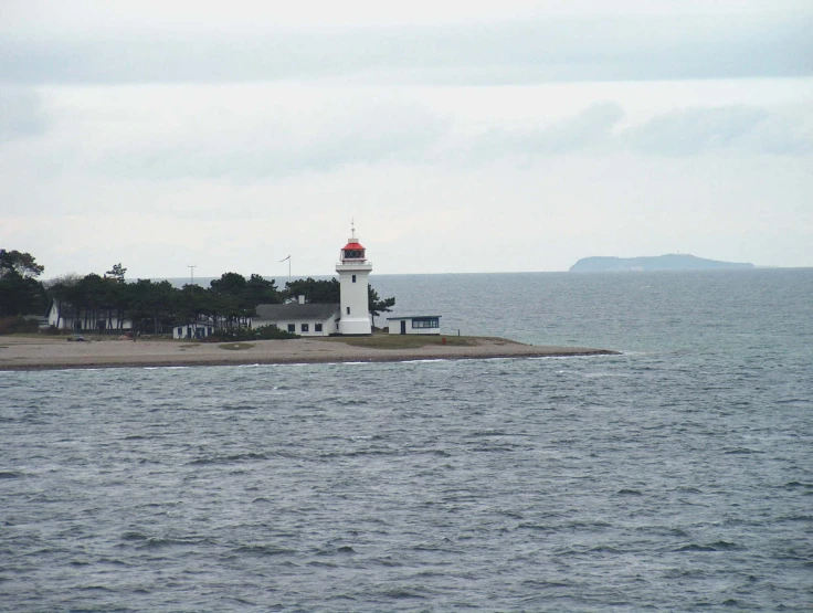 a lighthouse that is sitting on the side of a pier