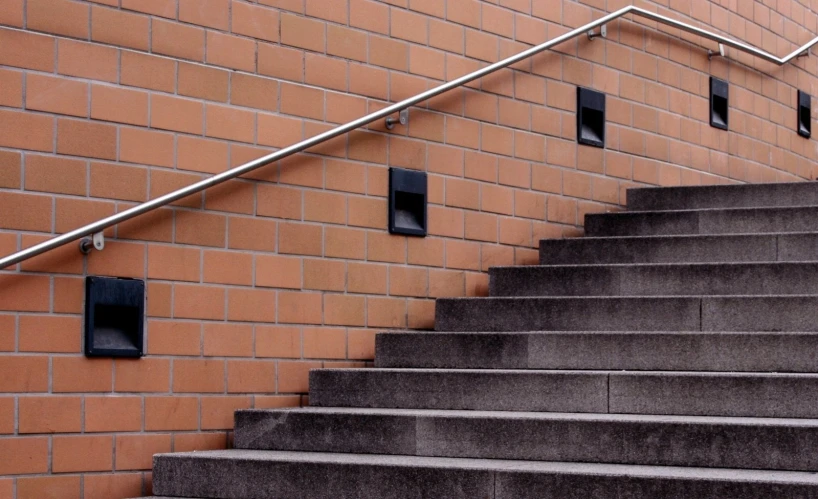 several black square light boxes mounted on some gray stone stairs