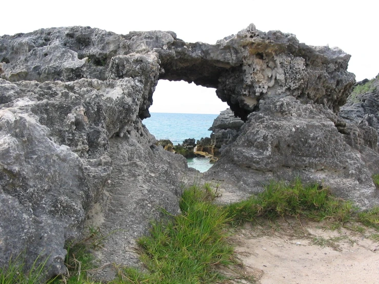 there is a hole in the rock on the beach