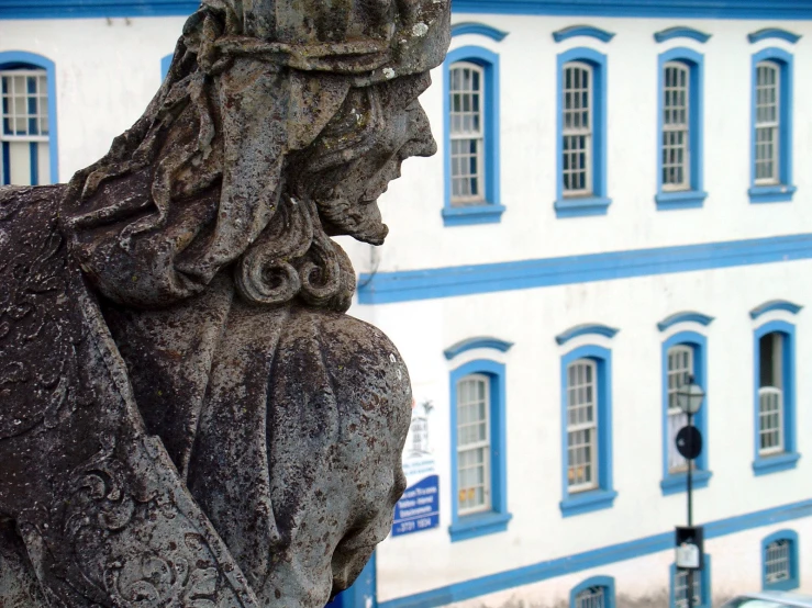 a statue of a woman outside a large building