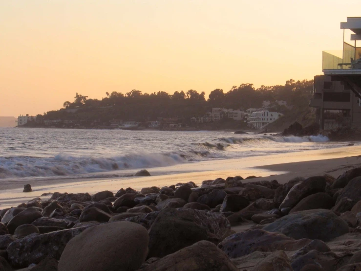 a beach with the ocean and els on the horizon