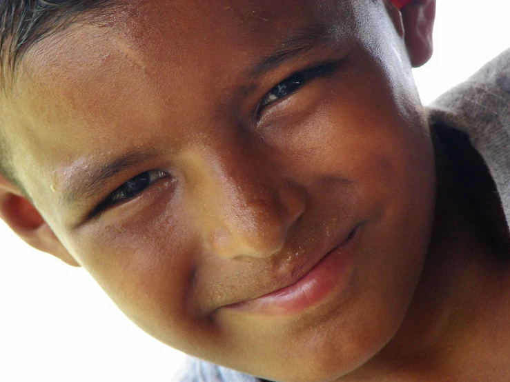 a smiling child with a piece of pizza