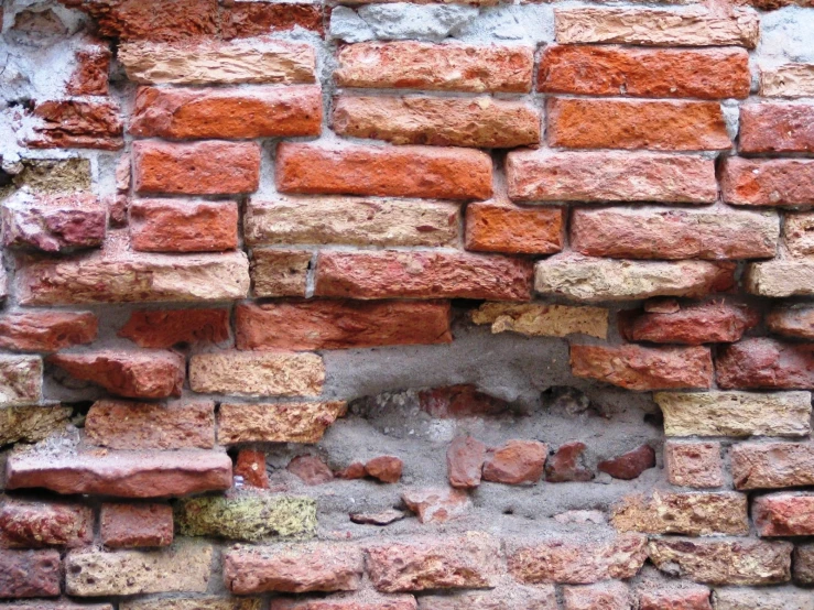 an old wall made from bricks is brick
