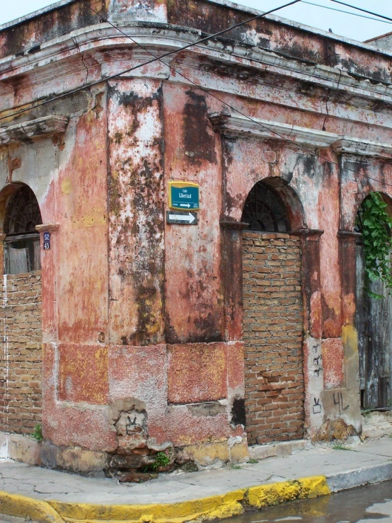 an old rundown building on the corner of the street