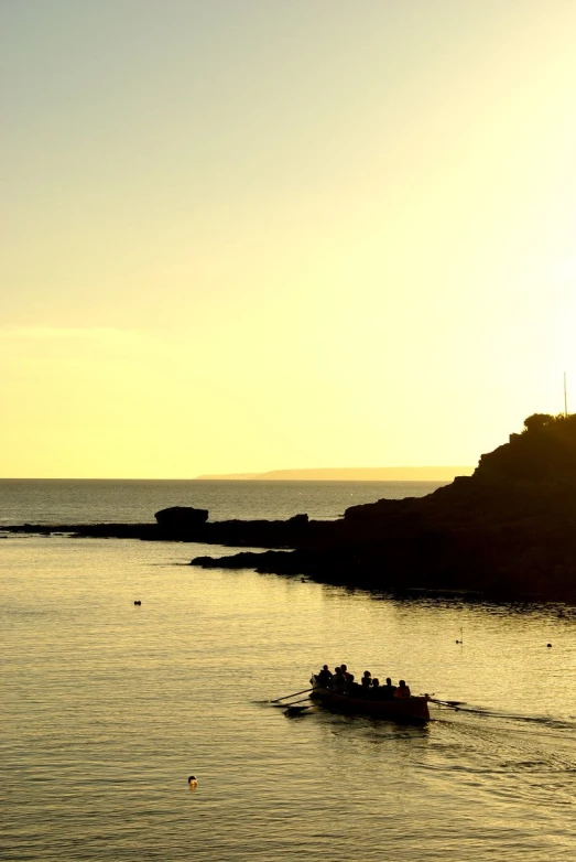 a boat with people in it is near some rocks