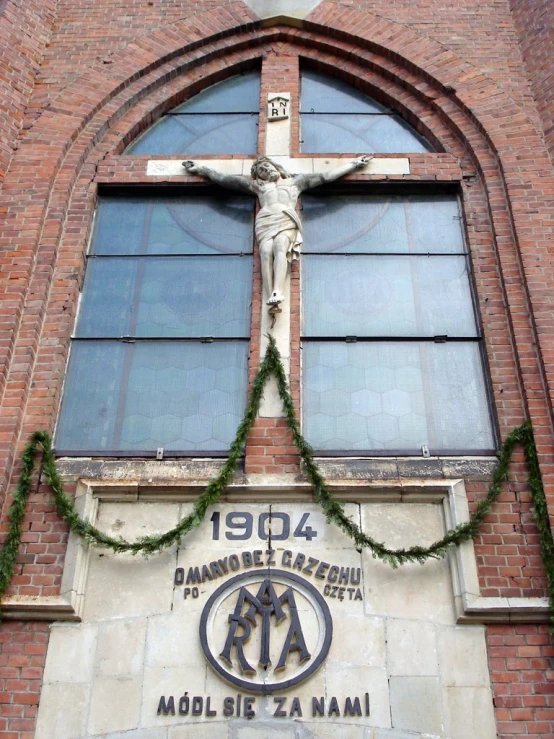 the front of a building with a wooden cross