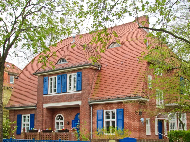 a brick building with blue shutters and windows