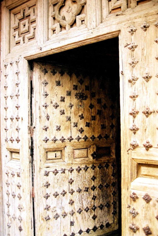 the wooden door is carved with various patterns