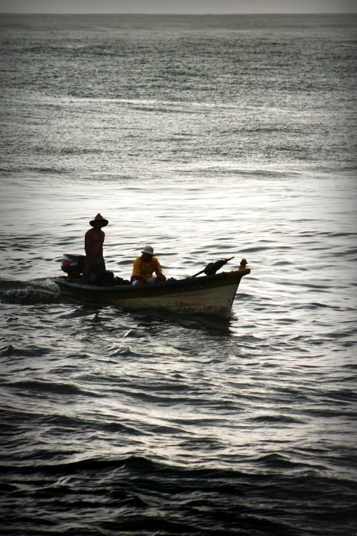 two people in a small boat on the ocean