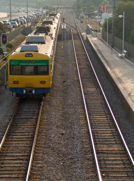 several trains with carts and cars are parked at the train station