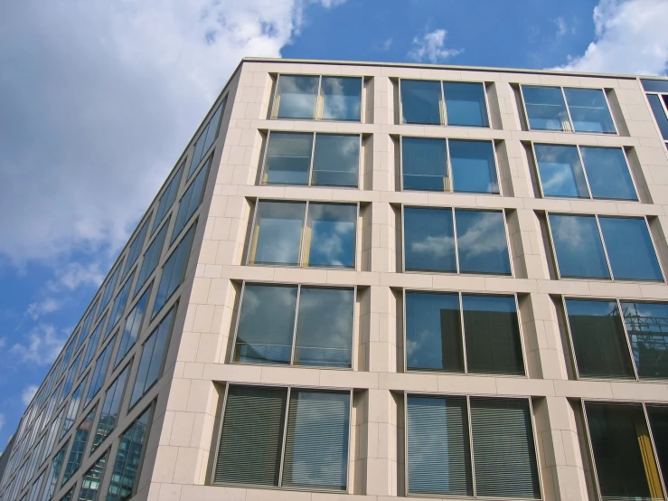 looking up at a tall building with many windows